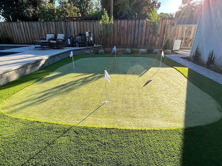Professional installation of modern putting green ideas featuring realistic turf and chipping areas